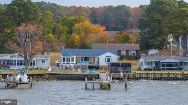 back of property featuring a water view