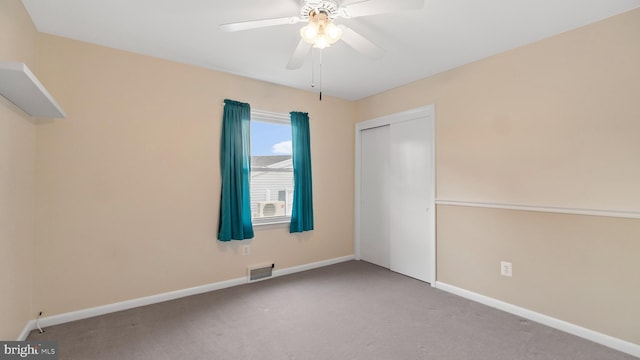 unfurnished bedroom with ceiling fan, light carpet, and a closet