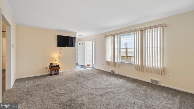 unfurnished living room with crown molding and carpet floors