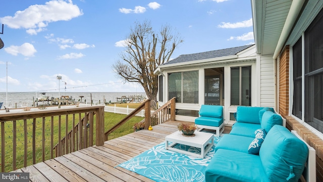 wooden terrace featuring an outdoor living space, a sunroom, a water view, and a lawn