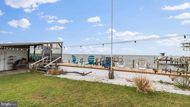 view of yard featuring a dock and a water view