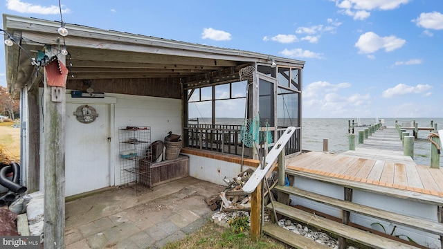 view of patio featuring a water view and a boat dock