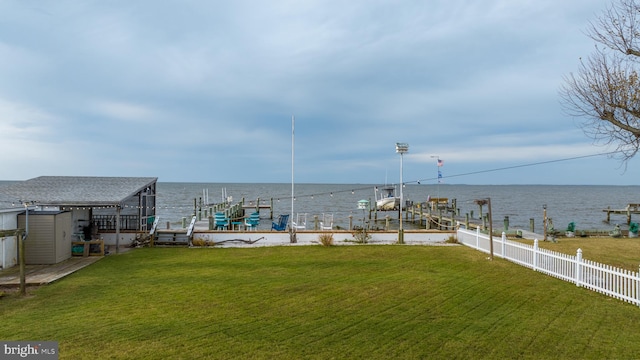 view of yard featuring a dock and a water view