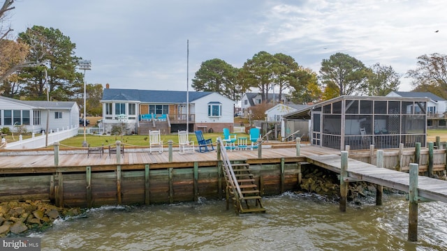 view of dock with a lawn and a deck with water view