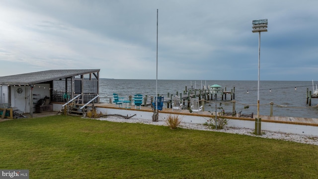 view of dock with a water view and a lawn