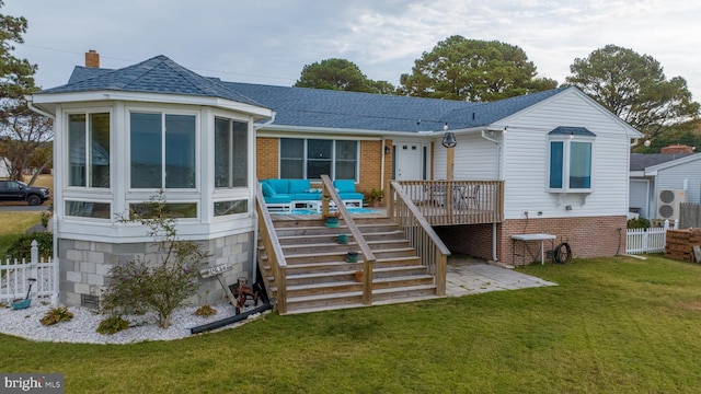 back of house featuring a patio area, a sunroom, a yard, and a wooden deck