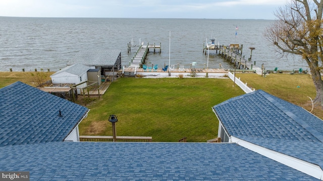 view of dock featuring a water view and a yard