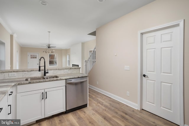 kitchen with white cabinetry, sink, light stone countertops, stainless steel dishwasher, and light hardwood / wood-style flooring