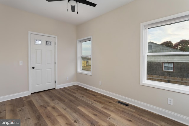 empty room featuring ceiling fan and dark hardwood / wood-style floors