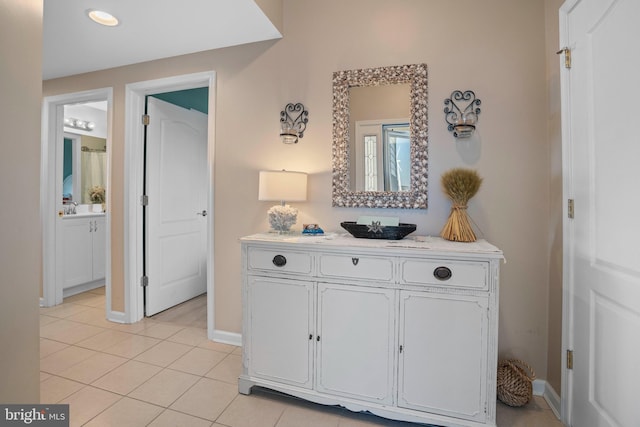 hall featuring light tile patterned floors