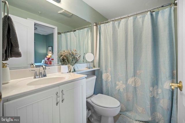 bathroom featuring vanity, toilet, and curtained shower