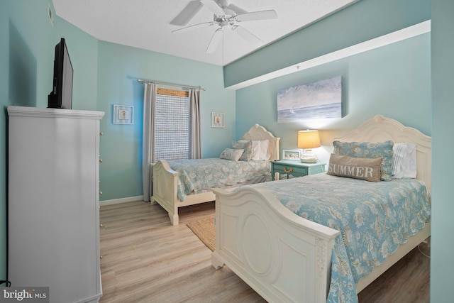 bedroom with ceiling fan and light wood-type flooring