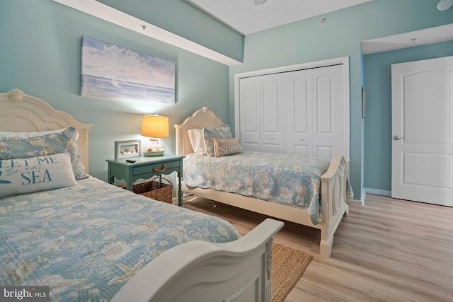 bedroom featuring light wood-type flooring and a closet