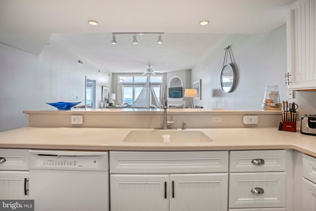 kitchen with white cabinetry, sink, white dishwasher, and ceiling fan