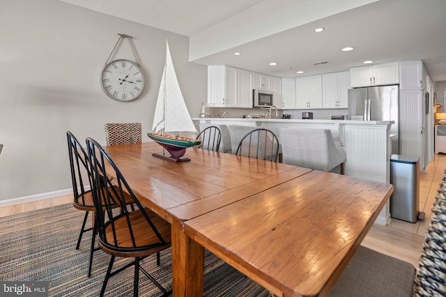 dining room featuring light hardwood / wood-style flooring and sink