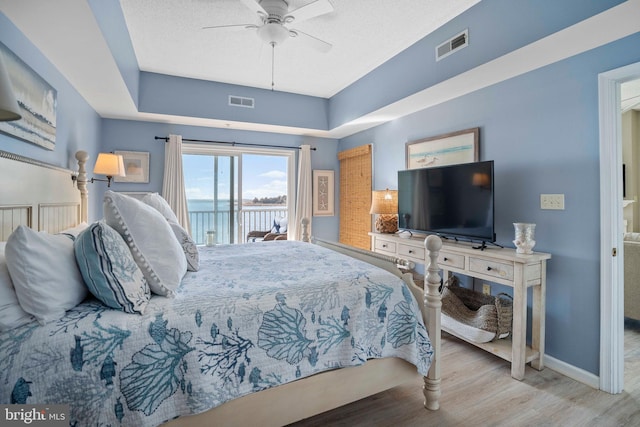 bedroom with access to exterior, ceiling fan, and light hardwood / wood-style floors