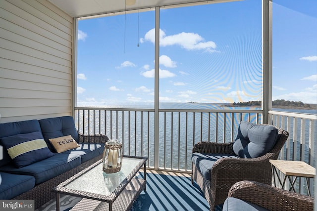 sunroom featuring a water view and a healthy amount of sunlight