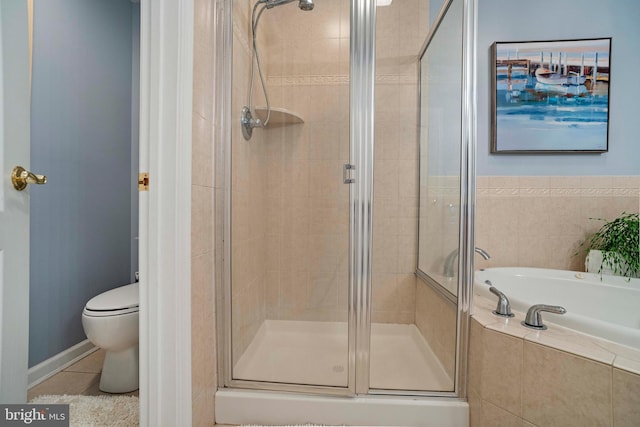 bathroom featuring tile patterned flooring, toilet, and independent shower and bath