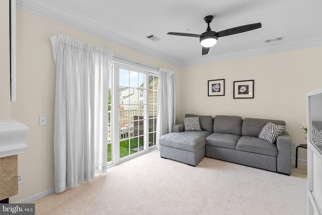 carpeted living room with ceiling fan and ornamental molding