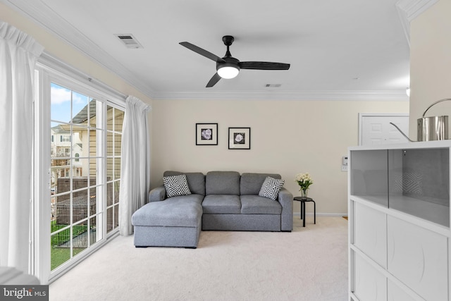 living room with carpet, ceiling fan, and crown molding