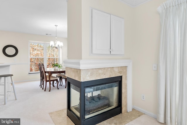 interior details with carpet flooring, a notable chandelier, a multi sided fireplace, and crown molding