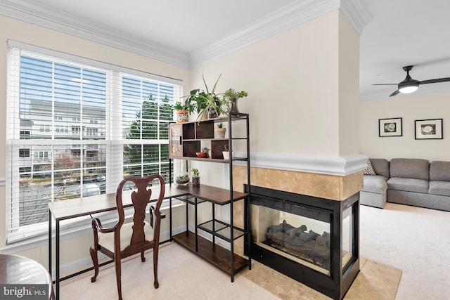 home office featuring a multi sided fireplace, ceiling fan, crown molding, and light carpet