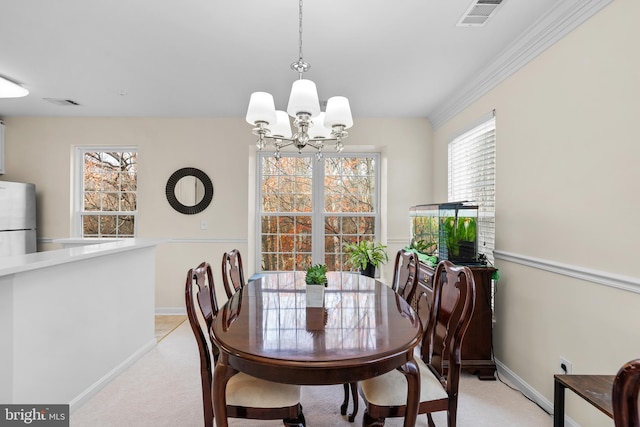 dining room with a notable chandelier and light carpet