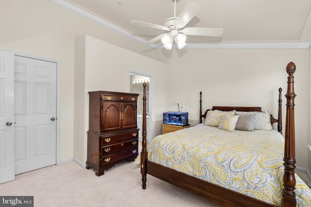 bedroom featuring a closet, light colored carpet, and ceiling fan