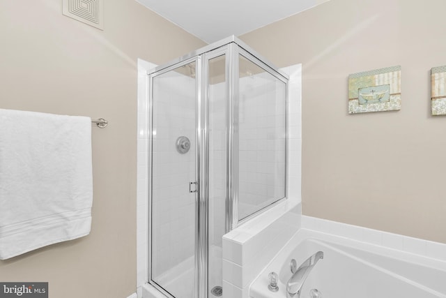 bathroom with separate shower and tub