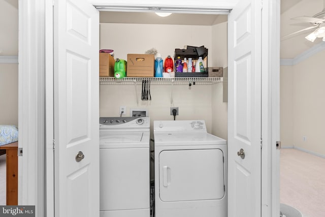 clothes washing area featuring carpet, washer and clothes dryer, ornamental molding, and ceiling fan