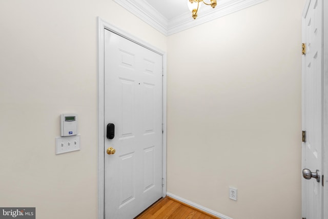 entrance foyer with light hardwood / wood-style floors and crown molding