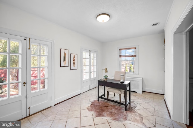 office area featuring light tile patterned flooring, french doors, visible vents, and baseboards