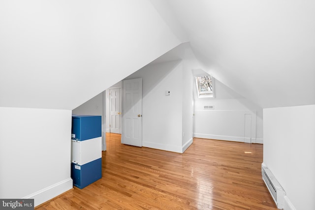 bonus room with visible vents, baseboards, light wood-type flooring, lofted ceiling, and baseboard heating