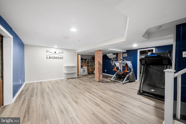 workout room featuring recessed lighting, baseboards, and wood finished floors