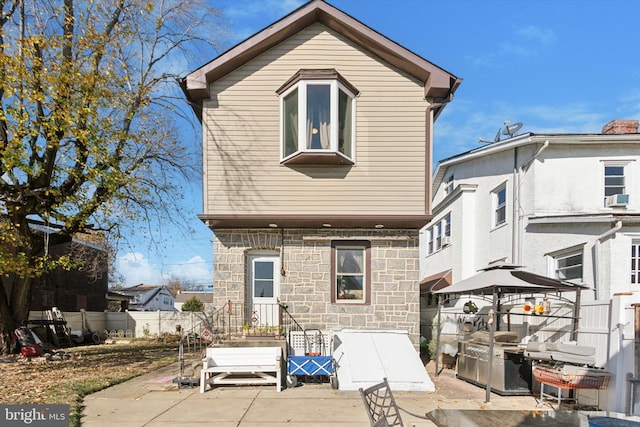 back of property with cooling unit and a patio