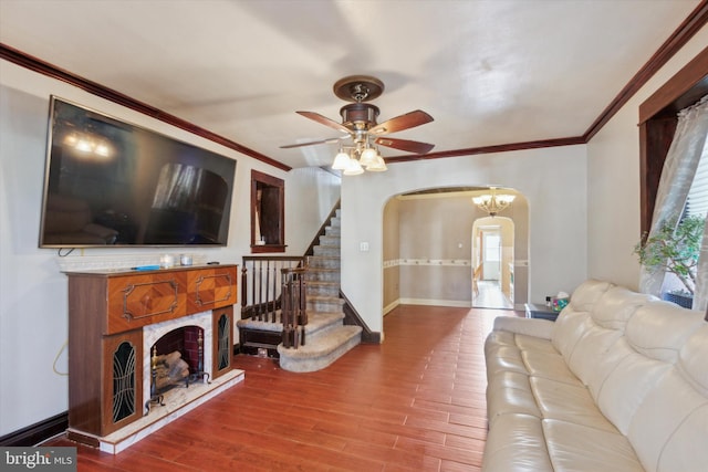 living room with hardwood / wood-style flooring, ceiling fan, and ornamental molding