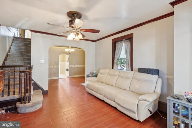 living room featuring ceiling fan, hardwood / wood-style floors, and crown molding