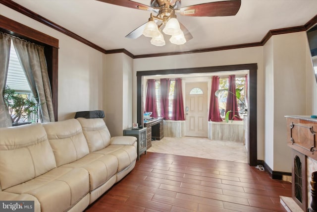 living room with ceiling fan, light hardwood / wood-style flooring, and ornamental molding