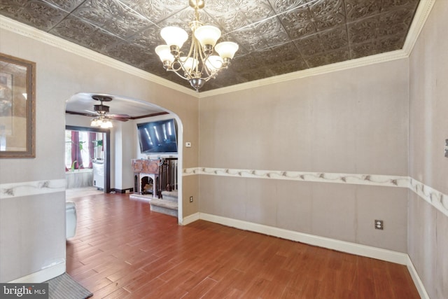 unfurnished room featuring hardwood / wood-style flooring, ceiling fan with notable chandelier, and ornamental molding