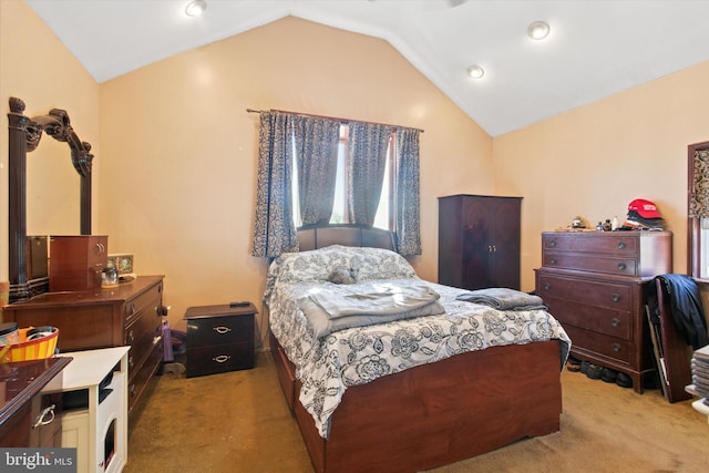 bedroom with lofted ceiling and light carpet