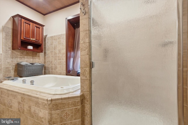 bathroom featuring shower with separate bathtub, tile walls, and ornamental molding