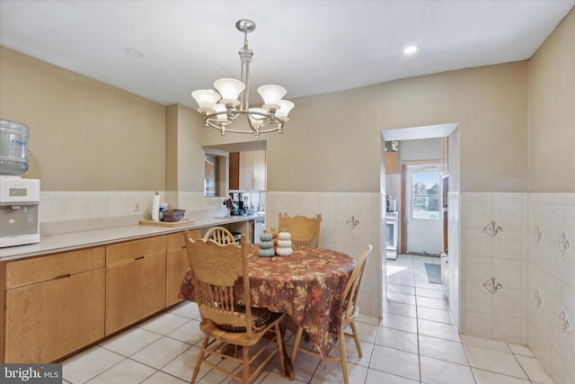 tiled dining space featuring an inviting chandelier