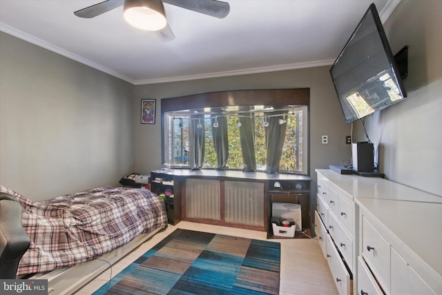 bedroom featuring ceiling fan and ornamental molding