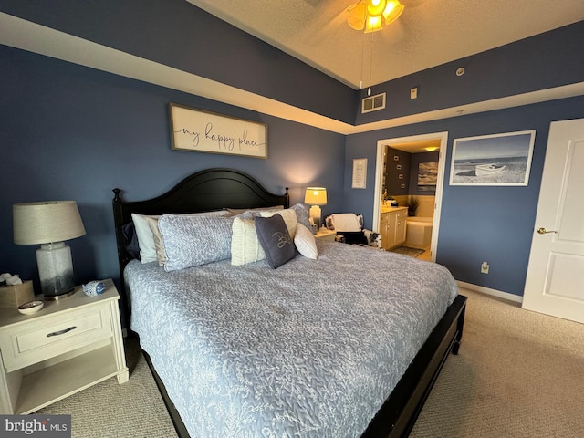 carpeted bedroom featuring ensuite bath and ceiling fan