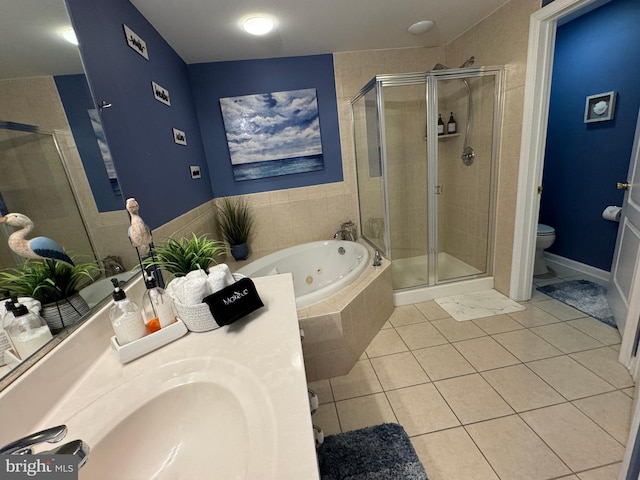 full bathroom featuring toilet, sink, tile patterned flooring, and separate shower and tub