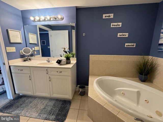 bathroom with tiled bath, tile patterned flooring, and vanity