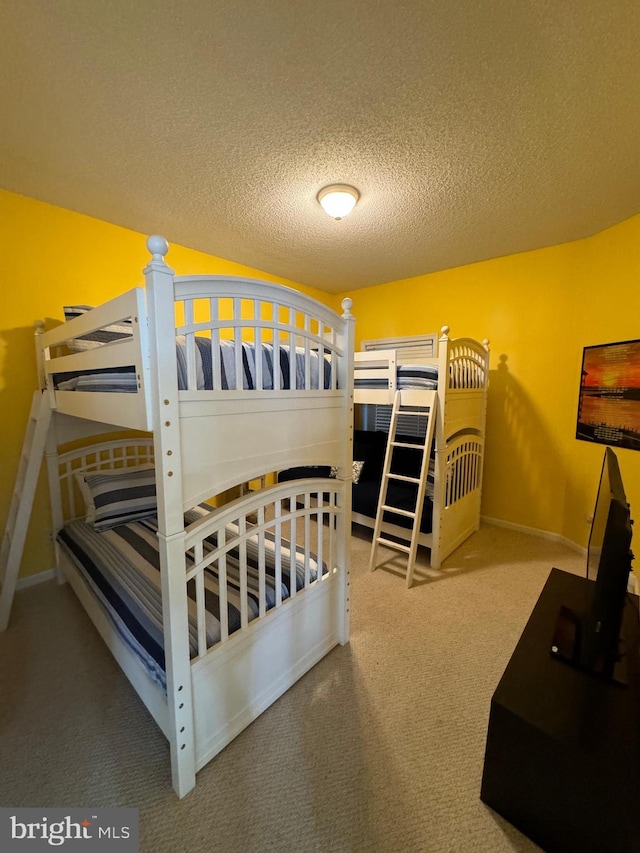 bedroom featuring carpet floors and a textured ceiling