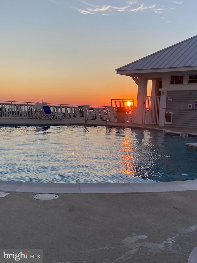 view of pool at dusk