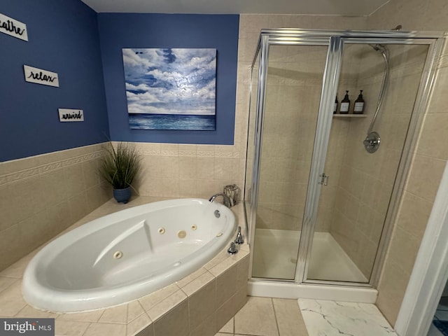 bathroom featuring separate shower and tub