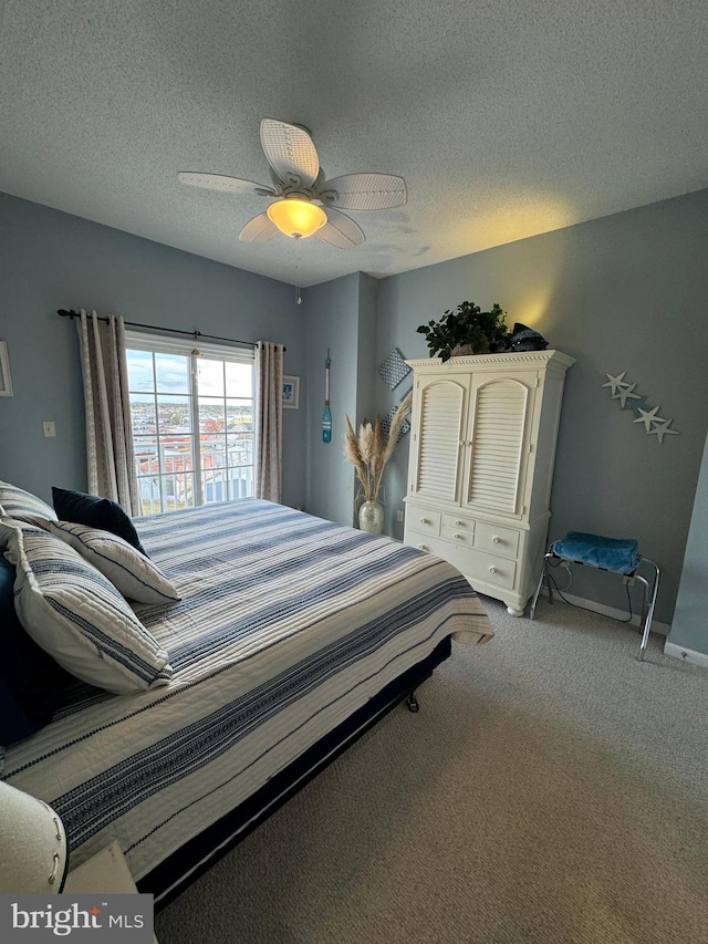 bedroom with ceiling fan, a textured ceiling, and light colored carpet